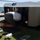 Hot tub with backside of a person sticking out, while installing the connections.
