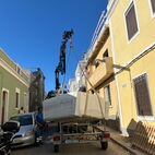Car trailer with hot tub in a small small one way street at the Algarve.
